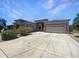Charming single-story home featuring a wide driveway and a well-manicured lawn at 2971 N Rosewood Ave, Casa Grande, AZ 85122