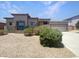 Single-story home with a three-car garage, neutral stucco, tile roof, and drought-tolerant landscaping at 2971 N Rosewood Ave, Casa Grande, AZ 85122