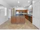Spacious kitchen with stainless steel appliances, wood cabinets and a large island at 2971 N Rosewood Ave, Casa Grande, AZ 85122