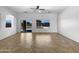 Bright, empty living room with tile floors and a large window looking out to the backyard pool at 2971 N Rosewood Ave, Casa Grande, AZ 85122