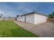 A nice backyard features a green lawn, a concrete patio, and a freshly painted stucco home at 3002 W Mandalay Ln, Phoenix, AZ 85053