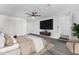 This bedroom has a ceiling fan, a TV, gray wood flooring, and a walk-in closet at 3002 W Mandalay Ln, Phoenix, AZ 85053