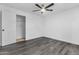 This bedroom offers wood-look flooring, a ceiling fan, a closet, and neutral paint at 3002 W Mandalay Ln, Phoenix, AZ 85053