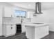 A modern kitchen with white cabinets, a center island, and stainless steel appliances at 3002 W Mandalay Ln, Phoenix, AZ 85053