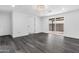 Living room featuring dark wood floors, white walls, and a sliding glass door at 3002 W Mandalay Ln, Phoenix, AZ 85053