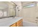 Bathroom with a long mirror over a vanity, paired with a shower-tub combo with white tile surround at 3150 E Beardsley Rd # 1091, Phoenix, AZ 85050