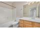 Bathroom with a bathtub and a light wood vanity with long mirror at 3150 E Beardsley Rd # 1091, Phoenix, AZ 85050