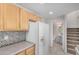 Bright kitchen offers oak cabinets, ample countertop space, and stairs leading to upper level at 3150 E Beardsley Rd # 1091, Phoenix, AZ 85050