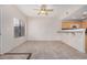 Open living room design with tile flooring, a ceiling fan, and breakfast bar seating at 3150 E Beardsley Rd # 1091, Phoenix, AZ 85050