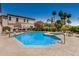 Community pool with a jacuzzi and ample seating, surrounded by palm trees and landscaping at 3150 E Beardsley Rd # 1091, Phoenix, AZ 85050