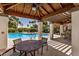 Poolside view with covered area, seating, and ceiling fan creating a relaxing outdoor space at 3150 E Beardsley Rd # 1091, Phoenix, AZ 85050