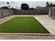 Backyard featuring an artificial lawn, concrete patio, brick trim, and gravel at 3517 E Blanche Dr, Phoenix, AZ 85032