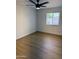 Bedroom featuring new laminate floors, a ceiling fan, and a bright window at 3517 E Blanche Dr, Phoenix, AZ 85032