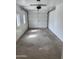 Spacious garage with painted white walls, natural light, and an automatic overhead door at 3517 E Blanche Dr, Phoenix, AZ 85032