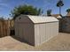Backyard featuring a metal storage shed surrounded by gravel and landscaping at 3517 E Blanche Dr, Phoenix, AZ 85032