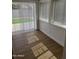 Sun room with new laminate floors, sunlight streaming through windows, and backyard access at 3517 E Blanche Dr, Phoenix, AZ 85032