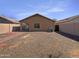 Desert landscaped backyard with gravel, brick patio, and privacy fence at 40168 W Sanders Way, Maricopa, AZ 85138
