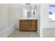 Another bathroom view showcasing neutral tiling, vanity, and tub with bright natural light at 40168 W Sanders Way, Maricopa, AZ 85138