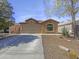 Charming single-story home featuring a neutral-toned exterior and a well-manicured desert landscape at 40168 W Sanders Way, Maricopa, AZ 85138