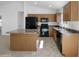 Bright kitchen featuring matching appliances, spacious countertops, an island and room for barstools at 40168 W Sanders Way, Maricopa, AZ 85138