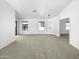 Spacious and bright living room featuring wall-to-wall carpeting, and ample natural light at 40168 W Sanders Way, Maricopa, AZ 85138