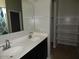 Bathroom featuring double sinks and a separate shelving unit at 4032 N 308Th Dr, Buckeye, AZ 85396