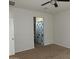 A bedroom with neutral colored carpet and access to an ensuite bathroom at 4032 N 308Th Dr, Buckeye, AZ 85396