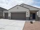 Charming single-Gathering home featuring a two-car garage and low-maintenance landscaping at 4032 N 308Th Dr, Buckeye, AZ 85396