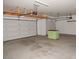 Spacious two-car garage featuring overhead storage racks and room for workbench at 4032 N 308Th Dr, Buckeye, AZ 85396