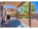 This backyard features a covered patio, well-manicured lawn, and ample space for outdoor activities and entertaining at 42406 W Posada Dr, Maricopa, AZ 85138