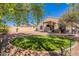 Backyard featuring rock landscaping, an artificial grass area, and a covered patio at 42406 W Posada Dr, Maricopa, AZ 85138