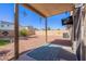 This backyard includes a covered patio, a view of the block wall and a comfortable space to enjoy the outdoors at 42406 W Posada Dr, Maricopa, AZ 85138