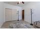This bedroom features a ceiling fan, closet and neutral color scheme for a bright and versatile space at 42406 W Posada Dr, Maricopa, AZ 85138
