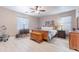 Primary bedroom with light hardwood floors, ceiling fan, and a bright window at 42406 W Posada Dr, Maricopa, AZ 85138