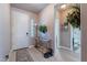 Inviting entryway with decorative rug, light hardwood floors, and a stylish table at 42406 W Posada Dr, Maricopa, AZ 85138