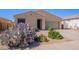 Charming single-story home featuring a desert-landscaped front yard with a two-car garage at 42406 W Posada Dr, Maricopa, AZ 85138