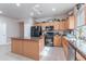 Modern kitchen featuring a center island, stainless steel appliances, and ample storage at 42406 W Posada Dr, Maricopa, AZ 85138