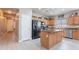 Open kitchen featuring a center island, stainless steel appliances, and light wood cabinets at 42406 W Posada Dr, Maricopa, AZ 85138