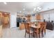 Bright kitchen featuring a breakfast nook, wooden cabinets, and a black refrigerator for modern living at 42406 W Posada Dr, Maricopa, AZ 85138