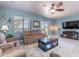 Inviting living room with a ceiling fan, plush couches, and a view of the outdoors through a window at 42406 W Posada Dr, Maricopa, AZ 85138