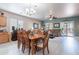 This open concept area shows living, dining, and kitchen in a well-lit space at 42406 W Posada Dr, Maricopa, AZ 85138