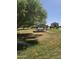 Community picnic area featuring a covered table and seating, with trees and grass at 42406 W Posada Dr, Maricopa, AZ 85138
