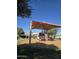 Community playground with play structure covered by a canopy, set on a wood chip base at 42406 W Posada Dr, Maricopa, AZ 85138