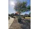 Community playground with play structure covered by a canopy, adjacent to a sidewalk at 42406 W Posada Dr, Maricopa, AZ 85138