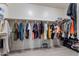 This walk-in closet offers ample storage space with clothing racks and shelving for organization and accessibility at 42406 W Posada Dr, Maricopa, AZ 85138