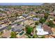 An elevated view of residential homes in a neighborhood highlighting well-maintained greenery and architectural uniformity at 511 E Port Au Prince Ln, Phoenix, AZ 85022
