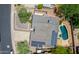 Aerial view showcases a home with solar panels, pool, mature trees, and well-kept landscaping at 511 E Port Au Prince Ln, Phoenix, AZ 85022