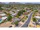 Expansive aerial view of a suburban community featuring lush landscaping, single-Gathering homes, and mountain views in the distance at 511 E Port Au Prince Ln, Phoenix, AZ 85022