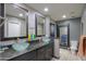 Modern bathroom with dual vessel sinks, granite countertops, and stylish mirrors at 511 E Port Au Prince Ln, Phoenix, AZ 85022