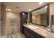 Stylish bathroom features dark cabinetry, granite countertop, and tiled walk-in shower at 511 E Port Au Prince Ln, Phoenix, AZ 85022
